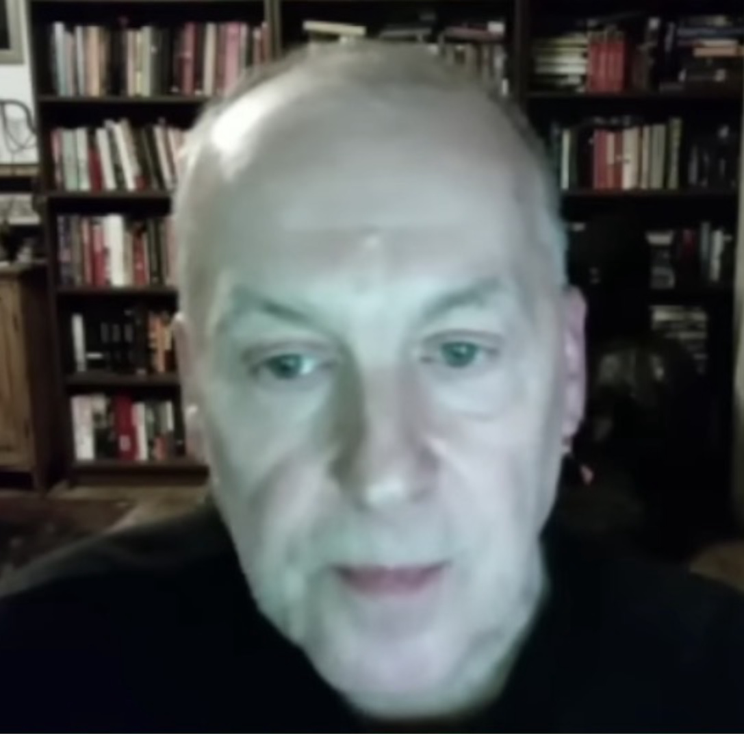 Portrait of philosopher Nick Land, a still frame from a webcam video, looking toward the camera.