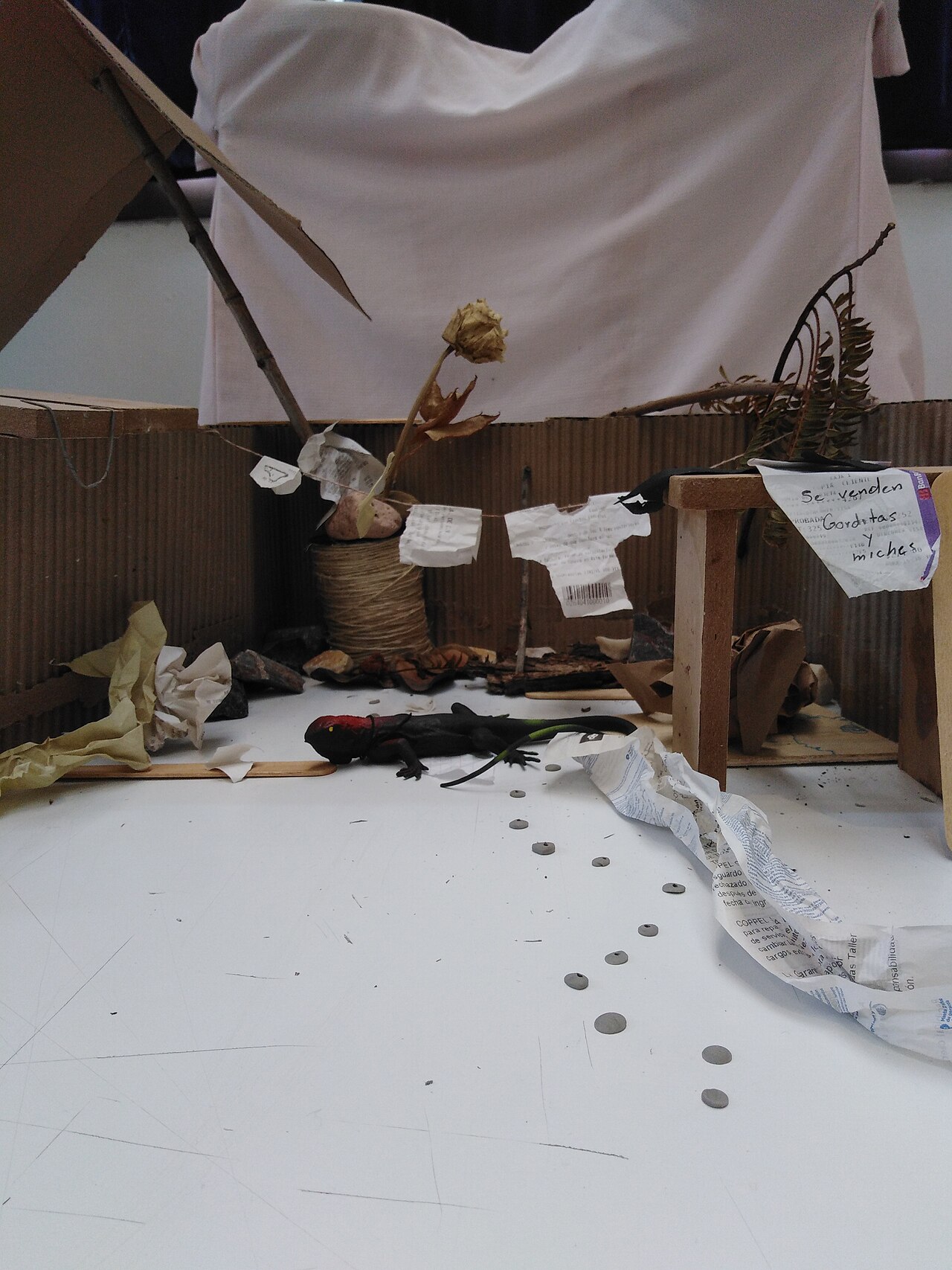 A student Arte Povera assemblage built from discarded objects and paper tickets gathered around a university.