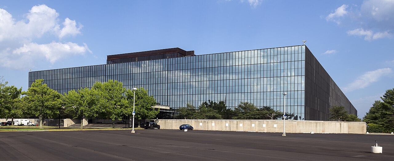 The long, low, mirror-glass Bell Labs Holmdel building, now Bell Works, seen across the grounds in Holmdel, New Jersey.