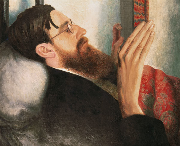 Painted portrait of Lytton Strachey reading, by Dora Carrington, showing his long face and beard in soft post-impressionist colour.