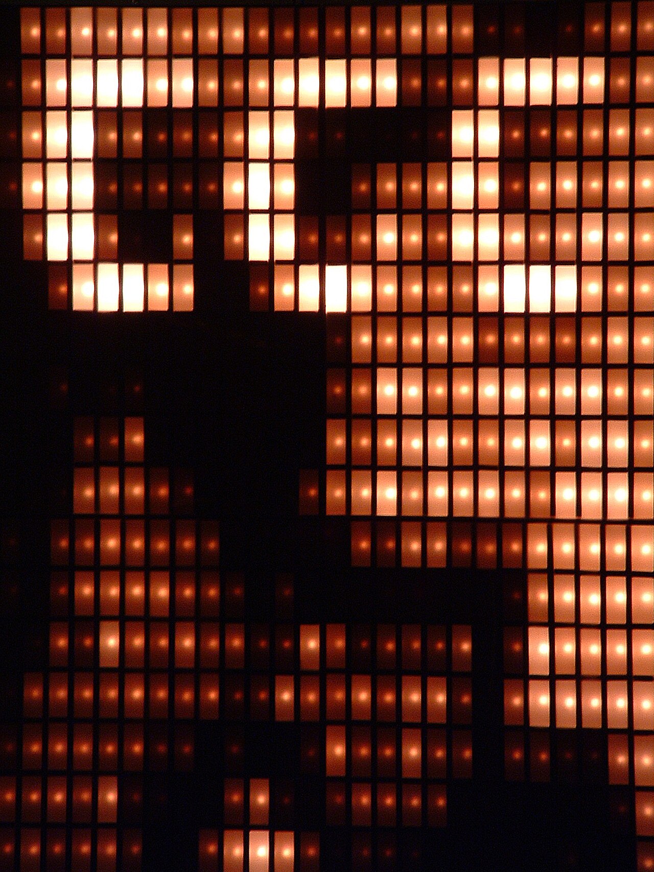 Amber Blinkenlights lamps glowing across a dark hall at the 22nd Chaos Communication Congress in Berlin.
