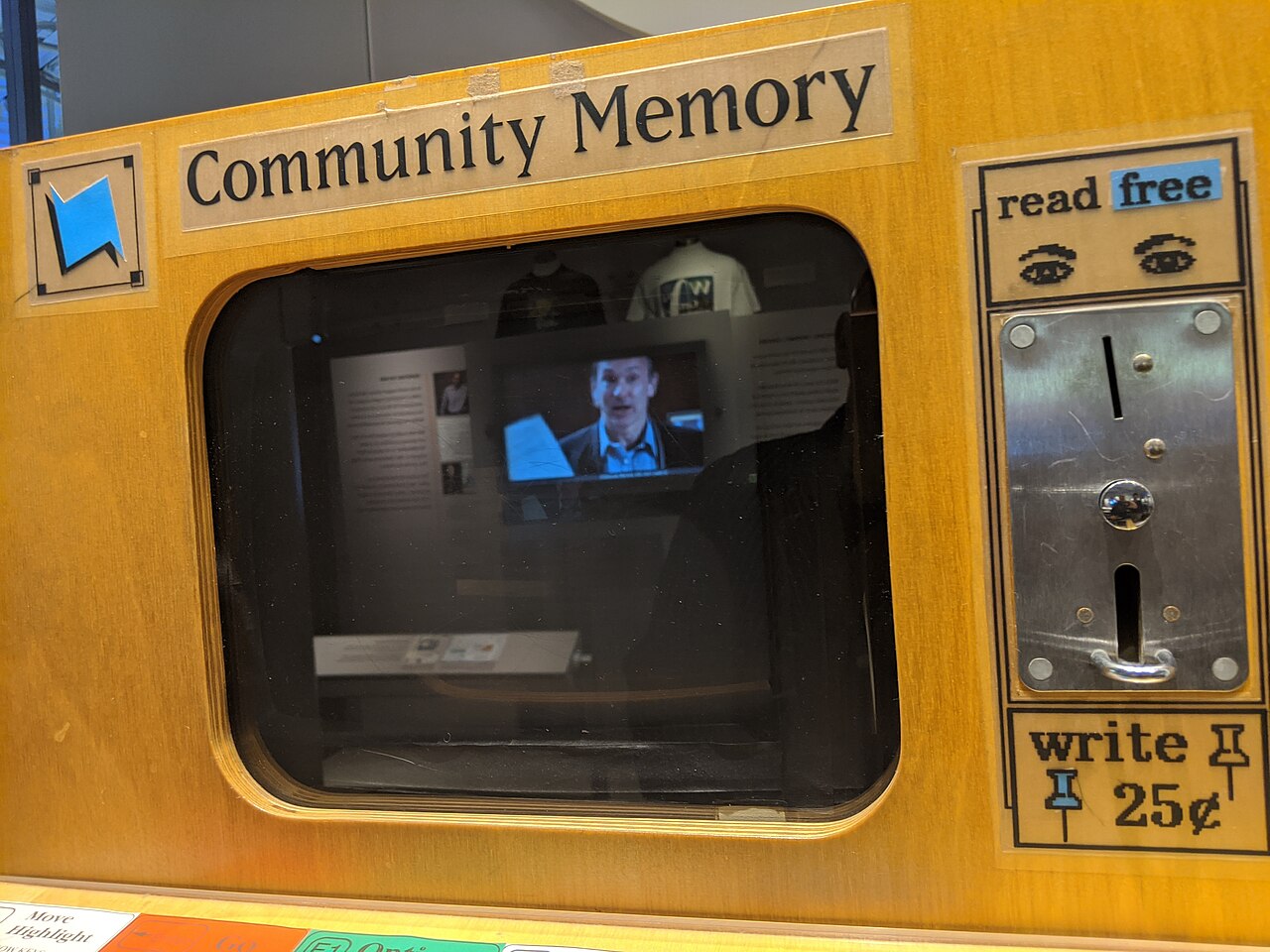 A Community Memory coin-operated workstation preserved at the Computer History Museum, showing its wooden cabinet, keyboard and screen.