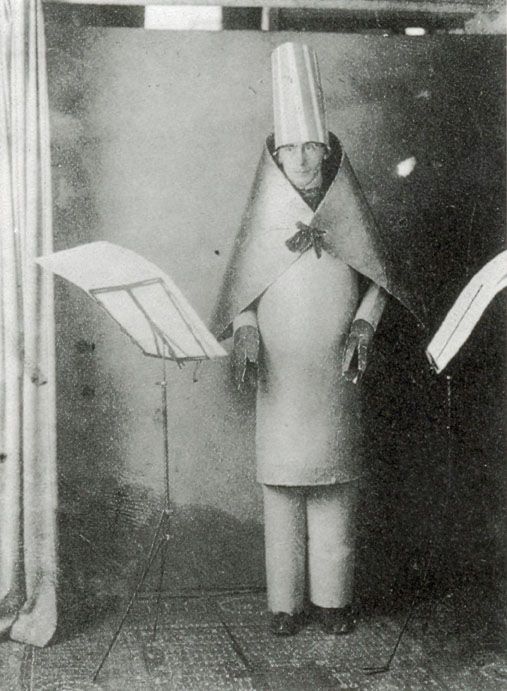 Studio photograph of Hugo Ball in his cylindrical cardboard costume for the sound poem Karawane, Cabaret Voltaire, 1916.