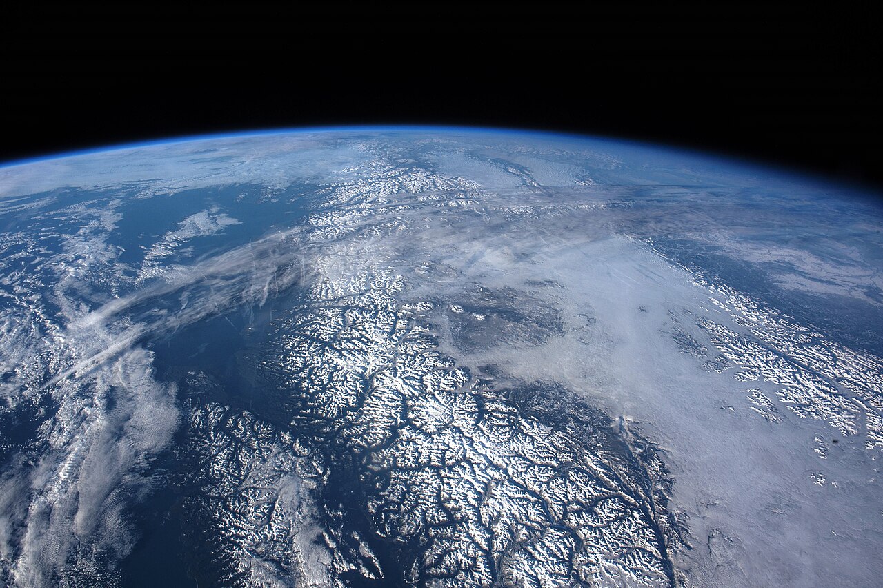 Snow-covered mountains seen from the International Space Station, looking north over the Gulf of Alaska toward the west coast of the United States.