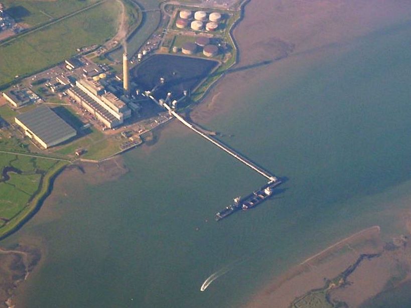 A coal-fired power station in England, cooling towers and chimney against the sky.