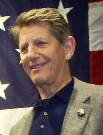 Peter Coyote photographed in 2008 at a campaign event in Manchester, New Hampshire, rendered in high-contrast purple duotone.