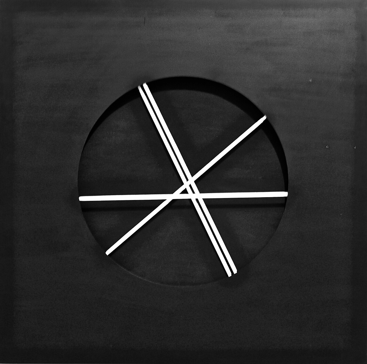 Pol Bury's Mélangeur (1961): white rods crossing a black disc set into a matte black panel, a slow kinetic geometry.