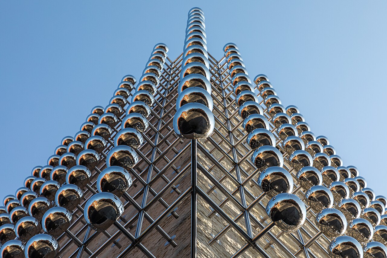 A wider view of Silberne Frequenz, the silver frequency of rods and spheres spanning the museum wall.