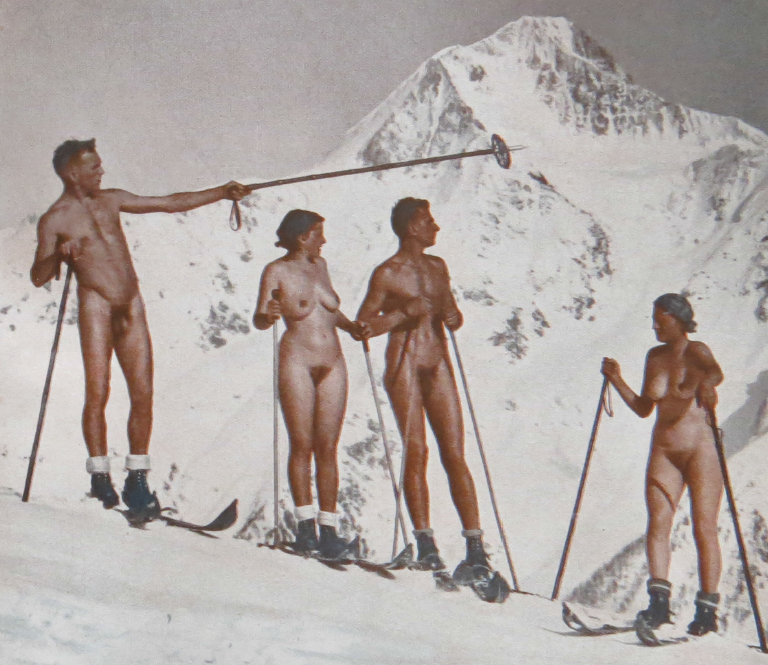 Four nude skiers pose with poles on a snowfield below an alpine peak, from a 1930 Swiss naturist magazine.