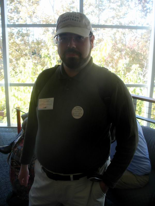 Eliezer Yudkowsky in 2008, wearing a cap reading "Bayesian Conspiracy."