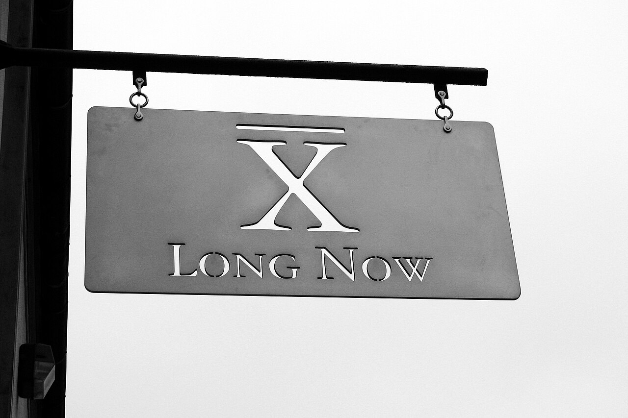 The painted sign of the Long Now Foundation on a San Francisco building.