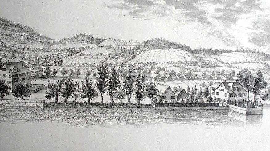 An 18th-century copperplate engraving of a lakeside villa and village among gentle hills, with a row of pollarded trees along the water.