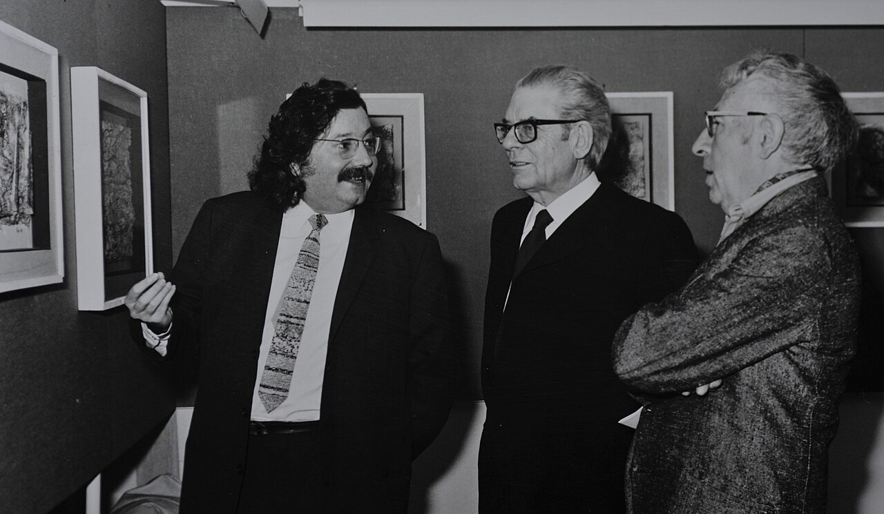 Three men together: the artist Brajo Fuso at centre, with Pierre Restany on the left and André Verdet on the right.