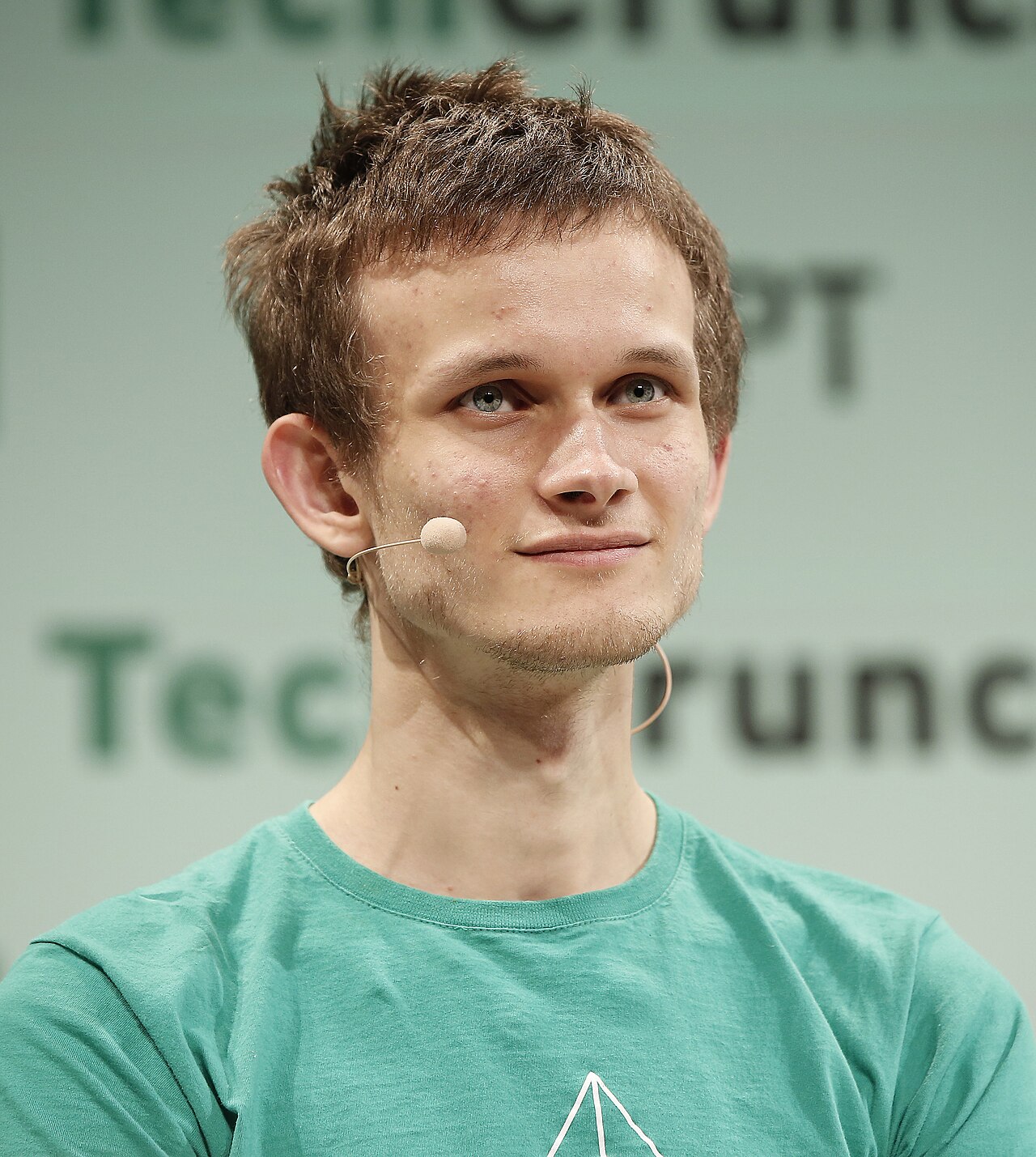 Portrait of Vitalik Buterin, founder of Ethereum, speaking at a conference in 2015; rendered as a vermilion-and-ink duotone poster.