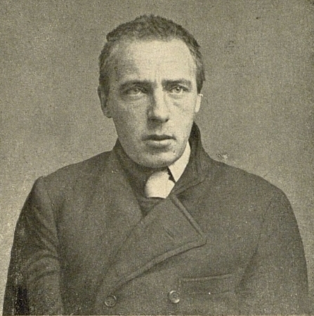 Sepia portrait of the poet Velimir Khlebnikov, gaunt and intent, in a dark coat, 1916.