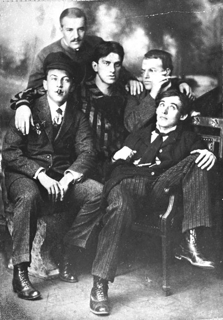 Group photograph of five young Russian Futurist poets posed together, cigarettes in hand.