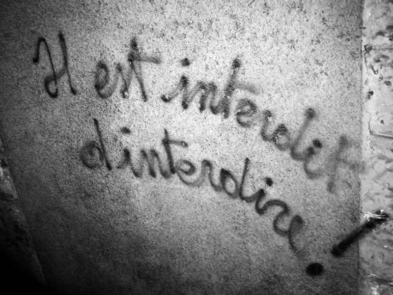 Situationist graffiti painted on a wall in Menton, France, reading 'Il est interdit d'interdire' — It is forbidden to forbid.