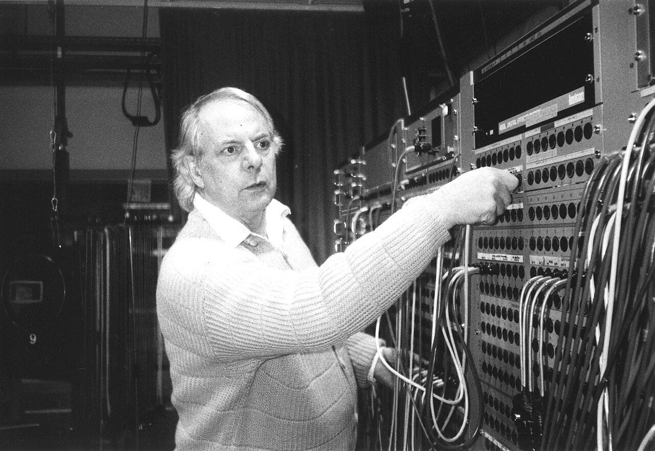 Karlheinz Stockhausen at the mixing desk of the WDR Studio for Electronic Music in Cologne, October 1994, surrounded by tape machines and outboard equipment.